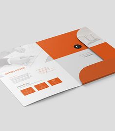 an orange and white business brochure is open to reveal the company's logo