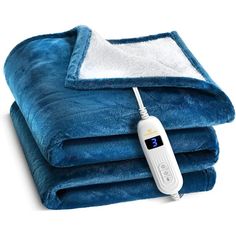 an electric heated blanket is shown on top of two blankets with thermometer attached to it