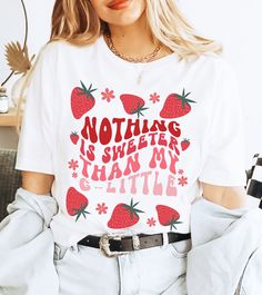 a woman wearing a t - shirt that says nothing is sweeter than my little