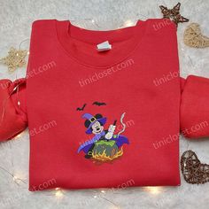 Mickey Witch Halloween Embroidered Shirt, Disney Halloween Embroidered T-shirt, Best Halloween Gift Ideas Tinicloset stands as a vibrant hub for self-expression, weaving threads of individuality into every stitch, and defining a canvas for unique style statements. With a passion for personalized fashion, Tinicloset curates an exquisite range of clothing, specializing in custom embroidered shirts, sweatshirts, T-shirts, and hoodies that serve as an embodiment of artistic finesse and personalized Disney Embroidered Crew Neck Tops, Disney Style Embroidered Cotton Tops, Disney Embroidered Cotton Tops, Cotton Mickey Mouse T-shirt For Fall, Disney Halloween Cotton T-shirt, Halloween Gift Ideas, Embroidered Shirts, Witch Halloween, Disney Halloween