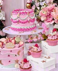 there are many pink cakes and cupcakes on the table