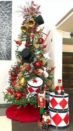 a christmas tree decorated with red, white and gold ornaments