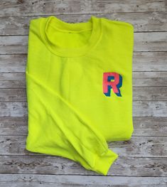 Neon color block shadow font sweatshirts.  Here's how to order: 1) Initials NO MORE than 3 letters 2) Thread color for top color 3) Thread color for the shadow ** If you do not select a color, the colors on the examples will be selected.  (The Sappire sweatshirt with neon yellow and neon pink thread). Yellow Color Block Crew Neck Sweatshirt, Yellow Color Block Cotton Sweatshirt, Yellow Cotton Color Block Sweatshirt, Neon Sweatshirt, Shadow Font, Pink Thread, Gildan Sweatshirt, Sweat Shirts, Gildan Sweatshirts