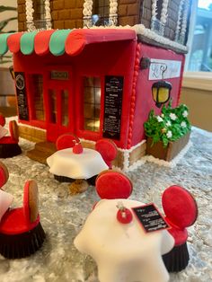 there is a cake made to look like a doll house with red and white decorations