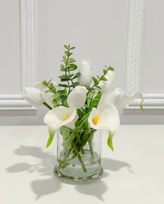 a vase filled with white flowers on top of a table