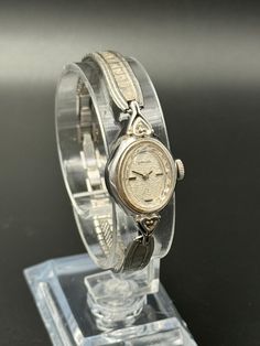 This exquisite vintage Baylor ladies watch showcases a timeless silver tone finish with a beautifully detailed textured bracelet and an elegant oval case. The intricate silver dial is adorned with delicate patterns, adding a touch of grace to this classic timepiece. Powered by a reliable mechanical movement, this watch runs and keeps time accurately. The case size is approximately 16.2mm, and it fits comfortably on a wrist size of up to 15.25cm. Please note the watch has minor cosmetic imperfections consistent with its age, which enhance its vintage character. --Please Read-- All sales are final except for damages in shipping or quality issues. Please feel free to ask questions before purchase. Offers are always welcomed, and we offer discounts for repeating customers. All international or Textured Bracelet, Vintage Character, Mechanical Movement, Women Wrist Watch, Ladies Watch, Wrist Watches, Vintage Watches, Jewellery And Watches, Time Piece