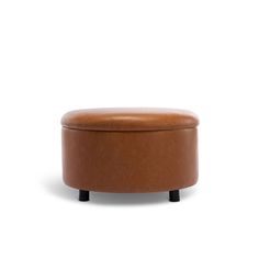 a brown leather ottoman sitting on top of a white floor