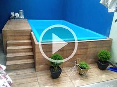 an above ground swimming pool with steps leading up to it and potted plants on the side