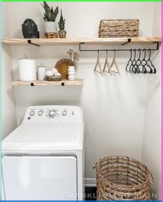 a washer and dryer in a small room with shelves on the wall above them