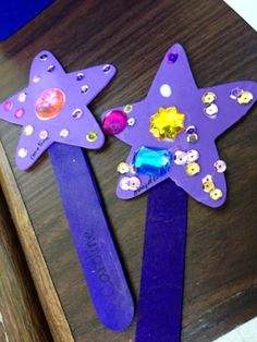 two purple hair clips with stars on them