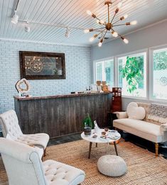 a living room filled with furniture and a bar