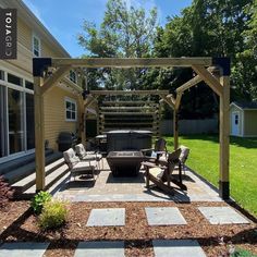 a patio with chairs and an outdoor hot tub