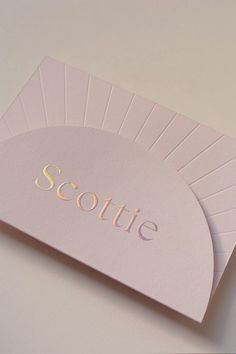 two folded cards with the word scottie on them are sitting next to each other