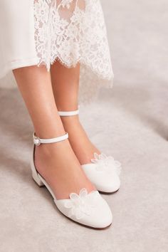 the bride's shoes are all white with bows