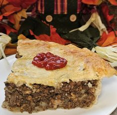 a piece of meat pie on a white plate