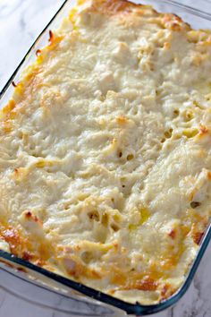 a casserole dish with cheese in it on a marble countertop, ready to be eaten