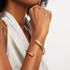 Expect to draw all the right kinds of attention with this sleek Soko Twisted Dash Cuff bracelet. Brass with 24K gold plate This bypass design subtly graduates to the widest open ends Adjustable style that flexes on and off for easy wear Handcrafted by artisans in Kenya using traditional techniques Luxury Gold Open Cuff Bangle, Modern Gold-tone Bangle With Polished Finish, Modern Gold-tone Bangle For Formal Occasions, Modern Gold-tone Formal Bangle, Gold Modern Cuff Bracelet For Formal Occasions, Modern Gold Cuff Bracelet For Formal Occasions, Modern Gold Cuff Bracelet With Jubilee Design, Modern Gold Bangle With Polished Finish, Gold Open Cuff Bracelet For Formal Occasions