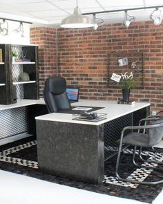 an office with brick walls and black chairs