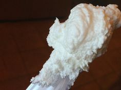 a close up of a toothbrush with some white stuff on it's tip