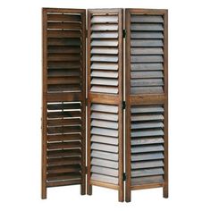 a wooden room divider with shutters on each side