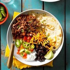 a white bowl filled with taco salad and black beans