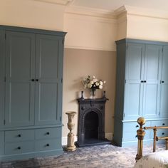 a bedroom with blue cabinets and a fireplace