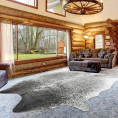 a large living room with two couches and a rug in front of the window