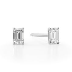 Elevate all your favorite looks with ease when you add these dainty emerald-cut diamond solitaire stud earrings in white gold. Created in 14K white gold Each earring showcases a 1/10 ct. emerald-cut diamond solitaire. Perfect for layering and stacking with other earring styles Shimmering with 1/5 ct. t.w. of diamonds These post earrings secure comfortably with friction backs. Timeless White Gold Emerald Cut Earrings, Timeless Emerald Cut White Gold Earrings, Fine Jewelry Emerald-cut Lab Grown Diamond Earrings, Classic Platinum Emerald Cut Diamond Earrings, Classic Emerald Cut Platinum Diamond Earrings, Classic Emerald Cut Diamond Earrings, White Emerald Cut Diamond Earrings, Emerald Cut White Gold Diamond Earrings, Classic Emerald Cut Diamond Earrings With Prong Setting