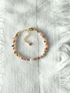 FOR OTHER DAINTY BEADED BRACELETS: https://www.etsy.com/ca/shop/ArtiChouXCanada?ref=seller-platform-mcnav%C2%A7ion_id§ion_id=46088511 Bracelet Length: 13-18cm (5.1-7 inches) with a 14k gold filled or sterling silver extender. This bracelet features a variety of stunning fall pastel colors: orange, brown, pink, cream, white, blue, and 18k gold filled seed beads. It also contains a freshwater pearl.  Thread may be visible since it is a handmade product   SIZING  Wrap a soft measuring tape snugly around the widest part of your wrist. Add 1.27cm (0.5in) to that measurement to determine the right bracelet size.  MATERIALS  - Japanese MGB glass seed beads(2x4mm) - 18K gold filled or sterling silver beads of 2mm - Freshwater pearl - 14K gold filled or sterling silver extender  CARE INSTRUCTIONS Adjustable Multicolor Pearl Bracelet With Colorful Beads, Adjustable Multicolor Hand-strung Pearl Bracelet, Adjustable Hand-strung Multicolor Pearl Bracelet, Bohemian Multicolor Adjustable Pearl Bracelet, Bohemian Pearl Bracelet With Colorful Beads And Adjustable Fit, Bohemian Adjustable Pearl Bracelet With Colorful Beads, Adjustable Bohemian Pearl Bracelet With Colorful Beads, Adjustable Pearl Bracelet With Colorful Beads, Multicolor Dainty Beaded Bracelets