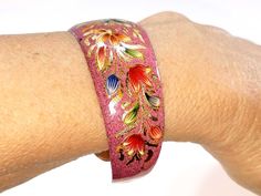 *Description: This is a beautiful vintage hand painted enamel on copper cuff bracelet from the 1960s. The floral painting is trimmed in gold paint. The bracelet fits a medium size wrist of 7 inches but can be adjusted as needed. It is a beautiful detailed bracelet and would make a wonderful gift and great cuff bracelet for your own jewelry collection. *Approximate Measurements: Bracelet Width - 1 Inch *Condition: Great vintage condition. May see wear under magnification. *Hallmark: Unsigned *Ite Formal Earrings, Book Pieces, Copper Cuff Bracelet, Enameled Copper, Copper Cuff, 1960s Vintage, Gold Paint, Star Earrings, Photo Jewelry