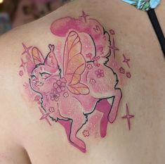 the back of a woman's shoulder with pink tattoos on it