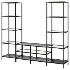 three black shelving units with shelves on each side and one shelf below the other