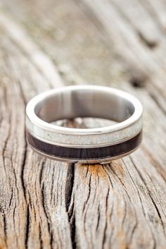 a wedding ring sitting on top of a wooden table