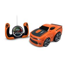 an orange toy car next to a steering wheel