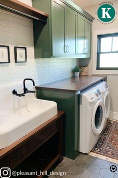 a washer and dryer in a small room with green cabinets on the walls