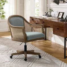 an office chair sitting on top of a rug next to a desk with a lamp