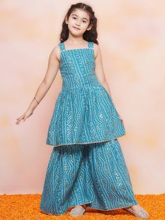 **Specifications : Please visit our brand store** https://www.etsy.com/in-en/shop/AJDezines?ref=seller-platform-mcnav .Kurta Fabric - Cotton | Sharara Fabric - Cotton .Package Content - 1 Kurta, 1 Sharara ||Style:- Kurta Sharara Set For Kids Girls .Top Details : Sleeveless , Bandhani Print, Square Neck, Cotton Fabric Bottom Details : Cotton Fabric, .Bandhani Print, .Specially Crafted Ethnic Set for the perfect look and comfort for the Summer Festive Season .Occasion: The Perfect set for Your Young Girls for Festival, Wedding, Birthday Gift and All function wear. Light, breathable and beautiful sharara set shall definitely be her go-to ethnic pick for any festive occasion. The Kurta and Sharara are made in Cotton, adorned with ornamental laces. The relaxed silhouette and natural material en Festive Sleeveless Dresses With Printed Motifs, Festive Sleeveless Bandhani Print Set, Festive Sleeveless Sets With Bandhani Print, Blue Printed Choli For Diwali, Blue Choli With Printed Motifs For Diwali, Fitted Dress For Diwali Festival, Diwali Blue Printed Choli, Blue Choli With Printed Motifs For Festivals, Blue Dresses For Navratri Celebration