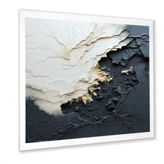 an abstract black and white painting with gold paint on it's edges, framed in wood frame