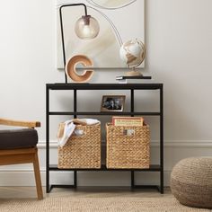 a black shelf with baskets and pictures on it