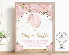 a pink hot air balloon baby shower sign with flowers and gold foil lettering on it