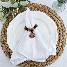 a white plate topped with a napkin on top of a table