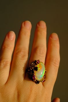 Elegant Oval Cabochon Rings With Natural Stones, Elegant Opal Ring With Natural Stones For Anniversary, Handmade Oval Opal Ring In Fine Jewelry Style, Unique Opal Rings With Gemstone Accents, Elegant Opal Ring With Natural Stones, Exquisite Oval Opal Ring, Unique Opal Ring With Gemstone Accents, Handmade Oval Opal Ring Fine Jewelry, Elegant Unique Opal Ring Gift