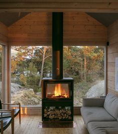 a living room filled with furniture and a fire place in the middle of a room