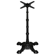 a black metal pole with four crosses on it's top and two legs in the middle