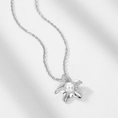 Description & Details Embrace the beauty of the sea with our meticulously crafted pieces that capture the essence of starfishes in stunning detail. From elegant starfish pendants to intricate starfish necklaces, our collection offers a range of styles to suit your unique taste. • Material: Solid 925 Sterling Silver ∙ Pearl ∙ Cubic Zirconia • Finish: Hypoallergenic ∙ Gold Plating•Dimensions: 40 - 45 cm chain , adjustable• All our work is custom made by hand with love Engagement Watch, Art Watch, Starfish Pendant, Starfish Necklace, Pearl Pendant Necklace, Star Pendant, Silver Pearls, Pearl Pendant, Solid 925 Sterling Silver