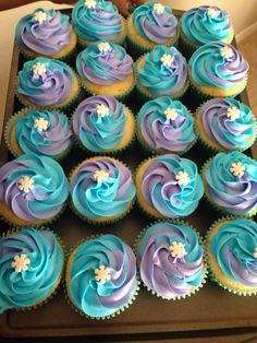 there are many cupcakes with blue and purple frosting