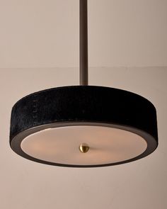 a black and white light fixture hanging from a ceiling