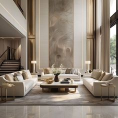 a large living room with white couches and tables