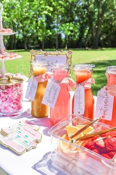 a table topped with lots of jars filled with liquid and food on top of it