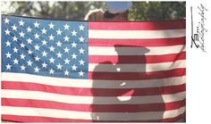 an american flag with the shadow of a person holding it